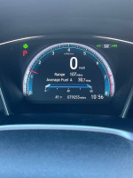 Dashboard display of a 2016 Honda Civic EX showing mileage and fuel efficiency.