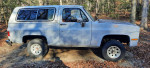 1990 Chevrolet Blazer with rebuilt engine and new parts parked in a forest setting.