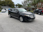 2010 Lincoln MKT with low mileage, showcasing its sleek design and features like panoramic sunroof and third-row seating.