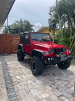2006 Jeep Wrangler Sport 4WD in excellent condition with modifications, parked on a stone driveway