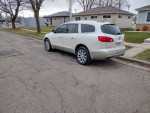 Side view of a 2013 Buick Enclave Limited in white parked on a residential street.