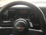 Dashboard of a 1989 Corvette convertible with speedometer and fuel gauges, showcasing performance metrics.