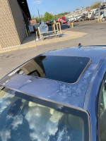 2004 BMW M3 roof with sunroof; vehicle in need of cosmetic touch-ups, showcasing Mystic Blue paint.