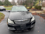 2013 Mercedes-Benz C300 4Matic in black, well-maintained, showing front view with all-wheel drive features.