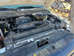 Engine bay of a clean 2006 F-250 with a 5.4 gas motor, featuring new plugs and coil packs.