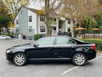 2009 Volvo S80 in black with beige interior parked outside, showcasing a clean exterior and smooth lines.