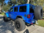 Blue Jeep Rubicon 392 with upgraded tires and suspension, garage kept, one owner, low miles.