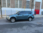 2009 Subaru Forester 2.5X in gray color, parked on city street with clean exterior and alloy wheels.