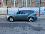 2009 Subaru Forester 2.5X in blue parked on the street with clean lines and clear windows.