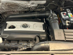 Engine compartment of a 2011 Volkswagen Tiguan with TSI logo and new components.