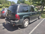 2003 Chevy Trailblazer 4x4 parked, featuring third-row seating for eight and tow hitch.