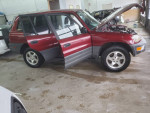 Red Toyota RAV4 with low mileage, clean title and engine hood open, displayed in garage setting