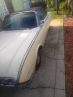 Classic 1961 Ford Thunderbird in good condition, parked outside with new tires and a sleek design.