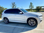 2015 BMW X5 M Sport in Mineral White, showcasing sleek design and modern features, parked outdoors.