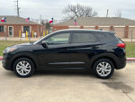 Side view of a 2019 Hyundai Tucson in excellent condition with new tires, leather seats, and a sleek black finish.