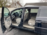 Interior view of a 2011 Honda Odyssey EX with open doors, showcasing spacious seating and dashboard.