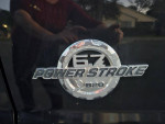 Close-up of the 6.7L Power Stroke Turbo Diesel badge on a Ford truck, showcasing its power and performance features.