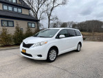 2011 Toyota Sienna LE AWD parked on a street, showcasing its excellent condition and family-friendly design.