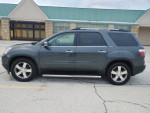 2011 GMC Acadia SLT-2 FWD in excellent condition, low mileage, parked outside a store.