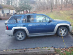 Blue 2006 Chevy TrailBlazer LT parked, featuring a cracked windshield and new sensors