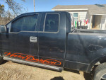 2006 Ford Harley Davidson truck with new tires and recent repairs parked outside a house.