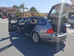 2011 BMW 3 Series wagon with open doors, showcasing spacious interior and cargo area for families.