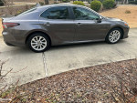 2023 Toyota Camry LE in excellent condition with low mileage parked on a driveway.