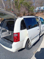 2010 Dodge Grand Caravan SXT with open trunk, versatile mini van for families or cargo.