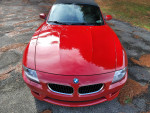 Top view of a red BMW Z4 M Roadster with low mileage, showcasing its sleek design and pristine condition.