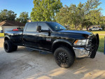 2018 Ram 3500 Big Horn Dually 4x4 in black with aftermarket wheels parked outdoors