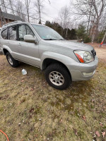 2006 Lexus GX 470 4WD parked on grass with custom modifications and off-road tires