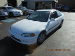1995 Honda Civic EX in white, featuring clean gray interior and sunroof, parked outdoors.