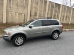 2008 Volvo XC90 with 111,000 miles, showing some exterior damage, parked on a residential street.