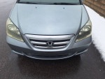 Front view of a silver Honda Odyssey, showing low mileage and excellent condition ideal for families.