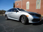 2021 Honda Civic EX in silver with 58,000 miles parked on a blacktop with brick building backdrop