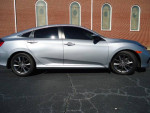Side view of a 2021 Honda Civic EX in silver, showcasing its sleek design and alloy wheels.
