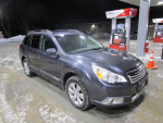 2012 Subaru Outback Limited parked at a gas station, showcasing its sleek design and well-maintained condition.
