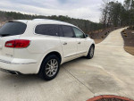 2013 Buick Enclave Leather Group parked on a driveway, showcasing its exterior and alloy wheels