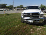 Front view of a 2018 Dodge Ram 2500 Diesel 4X4 truck parked on grass, ready for work with a clean design.