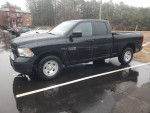 2015 Ram 1500 truck with low mileage, turbo diesel, push-button 4WD, and modern tech features parked in a lot.
