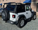 2020 Jeep Wrangler in white with a soft top, upgraded features, and a heavy duty roof rack for outdoor adventures.