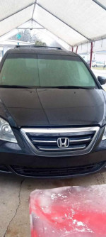 2006 Honda Odyssey Touring FWD parked under a shelter with a frosted windshield.