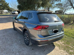 2018 Volkswagen Tiguan SE 4Motion SUV in gray with white interior, parked outdoors near trees.