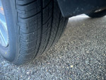 Close-up of a tire with good tread on a 2014 Sienna XLE, showcasing vehicle maintenance and safety features.