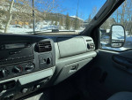 Interior view of a 2006 Ford F-250, featuring dashboard and controls, designed for trucks and plowing.