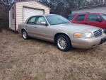 1998 Ford Crown Victoria LX in gold, garage kept, excellent condition, low mileage, displayed outdoors.