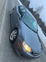 2007 Saab 9.3 sedan with turbo, good condition, includes winter tires, parked on the roadside in snowy weather.