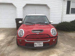 Front view of a red 2005 MINI Cooper S parked outside with unique modifications.