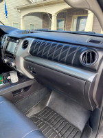 Interior view of a 2014 Toyota Tundra Platinum with leather seats and touchscreen display.