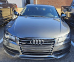 2013 Audi A7 Premium Plus quattro in Quartz Gray Metallic, showcasing a sleek front view with luxury features.